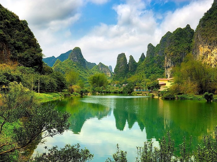 Green lake surrounded by karst mountains in China