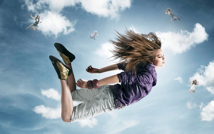 Girls falling through the sky with clouds
