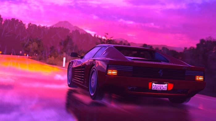 Red Ferrari 512 TR driving on a road at sunset