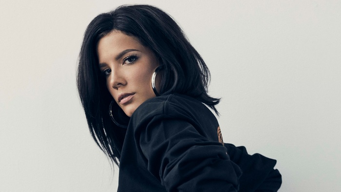 Halsey wearing a black sweatshirt and hoop earrings