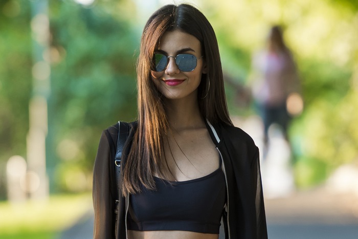 Victoria Justice wearing sunglasses and a black top
