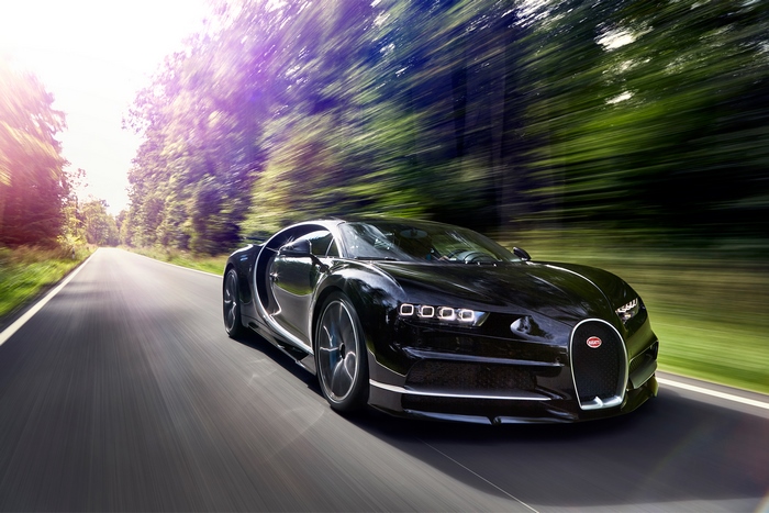 Black Bugatti Chiron driving on a road