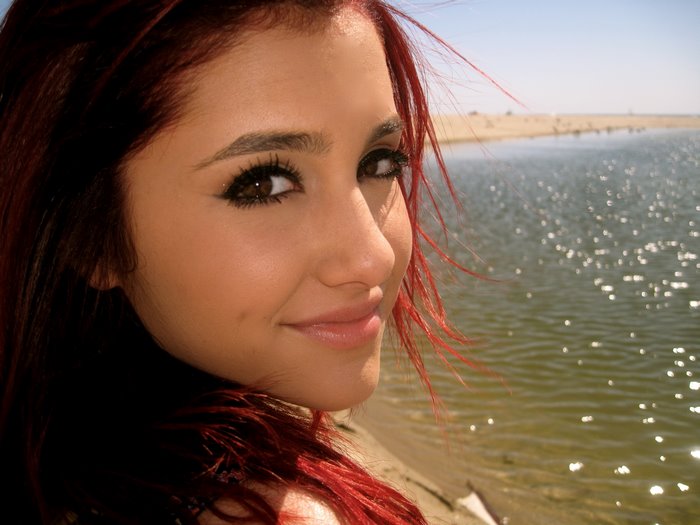 Ariana Grande by a body of water