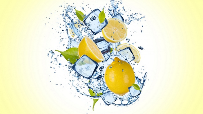 Lemons with ice cubes and water splash