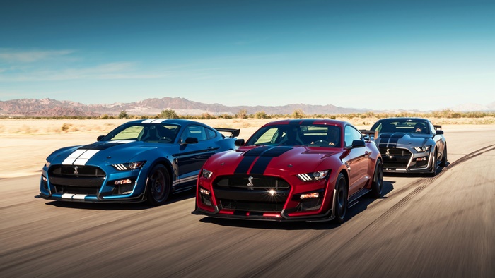 Three Ford Mustang Shelby GT500 cars on a road