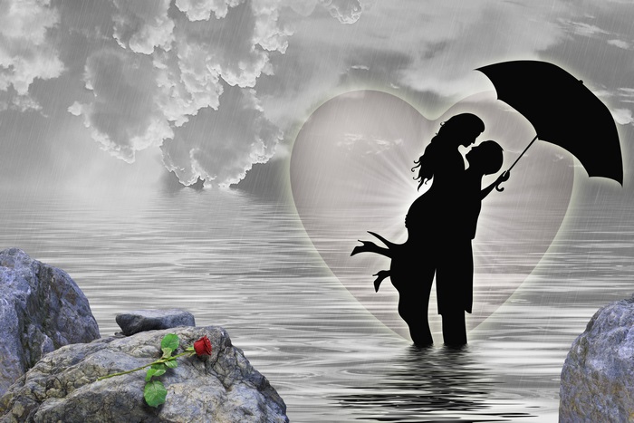 Couple in Silhouette Under Umbrella in Heart Shape