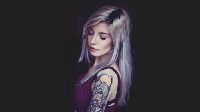 Woman with blonde hair and a tattoo