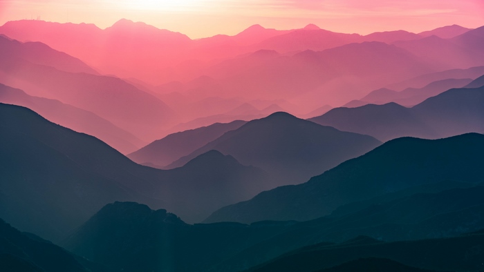 Layered mountains at sunset