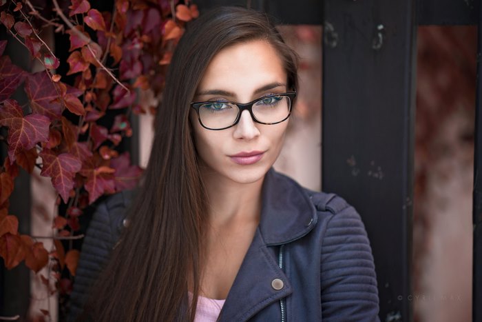 Woman with long brown hair and glasses