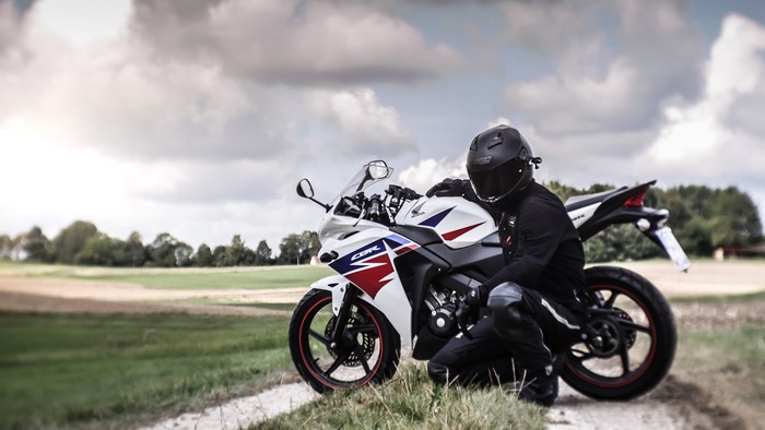 Honda CBR motorcycle with a biker in a field