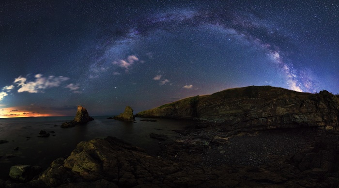 Milky Way over rocky coastline at night