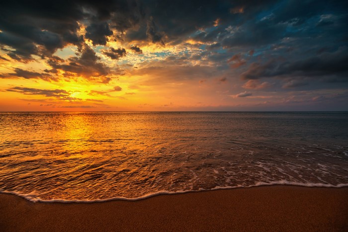 Sunset over the ocean with dramatic clouds