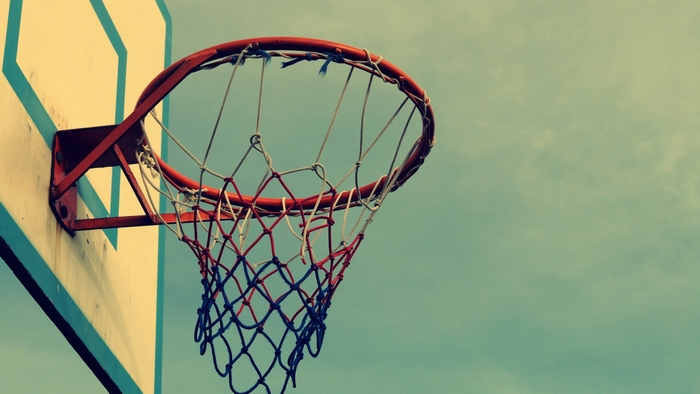 Basketball hoop and net against a cloudy sky