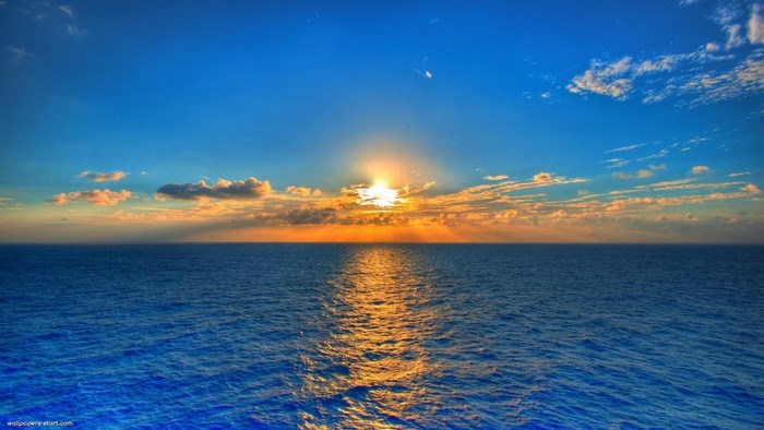 Sunset over the ocean with clouds