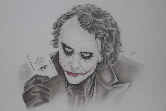 The Joker holding a Joker card