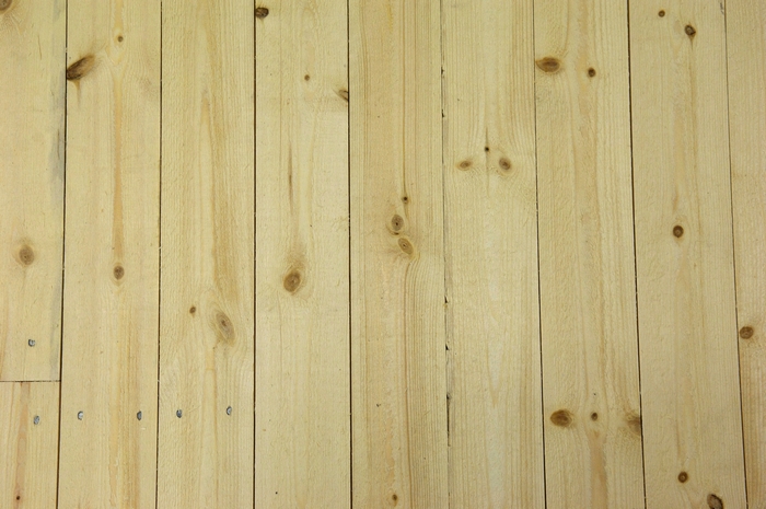 Light brown wooden planks with knots and nails
