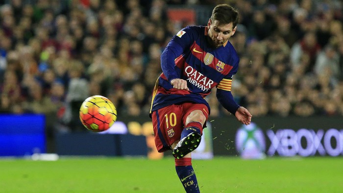 Lionel Messi kicking a soccer ball