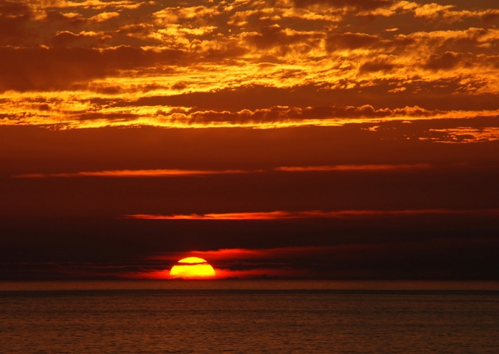 Sunset over the ocean with clouds