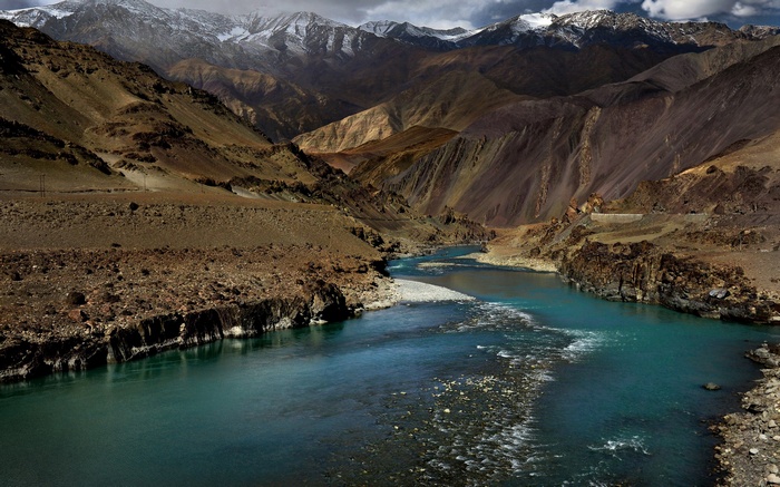 Confluence of two rivers in a mountainous landscape