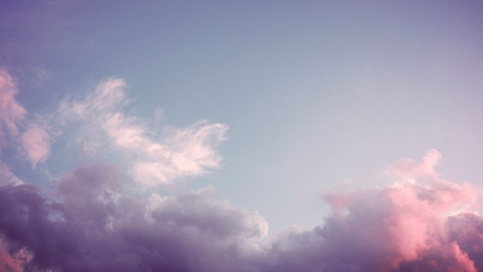 Purple and pink clouds in a blue sky