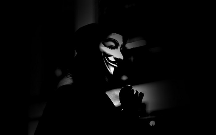 Anonymous mask person in dark