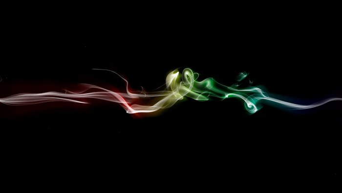 Colorful smoke wisps on black background