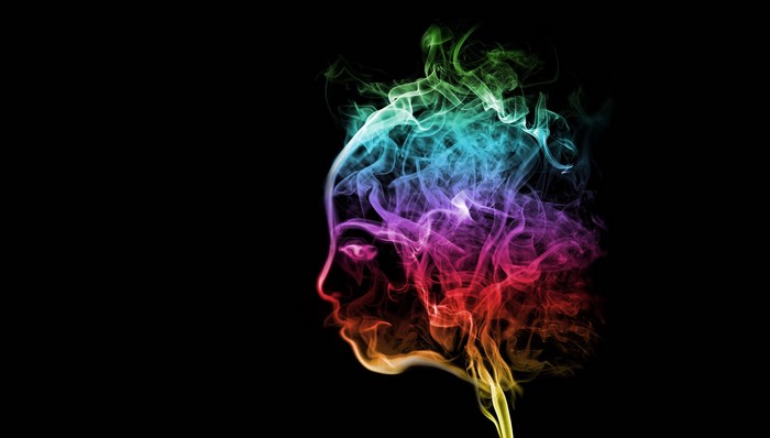 Colorful smoke forming a human profile