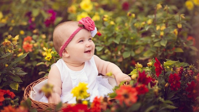 Smiling Baby with Flower Headband in Garden