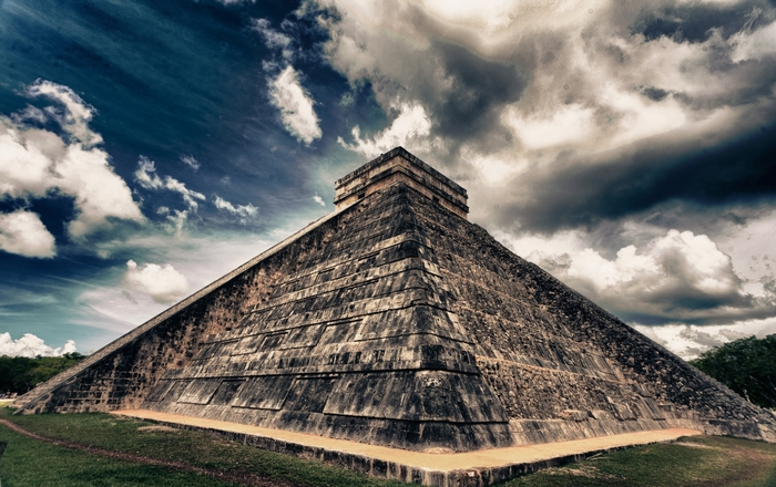Chichen Itza pyramid in Mexico under cloudy sky