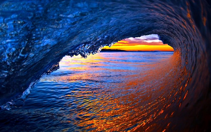 Wave crashing at sunset