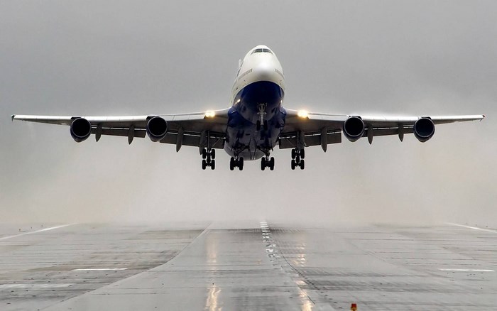 Boeing 747 taking off on a wet runway