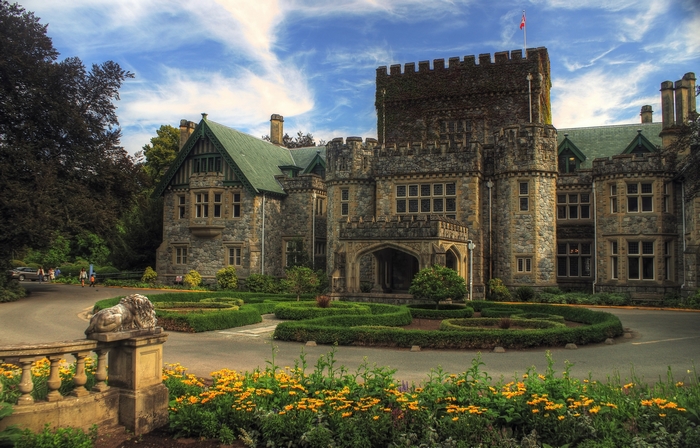 Castle with manicured gardens and lion statue