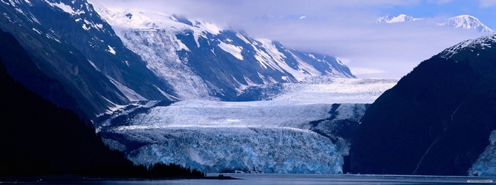 Glacier and snow-capped mountains over water