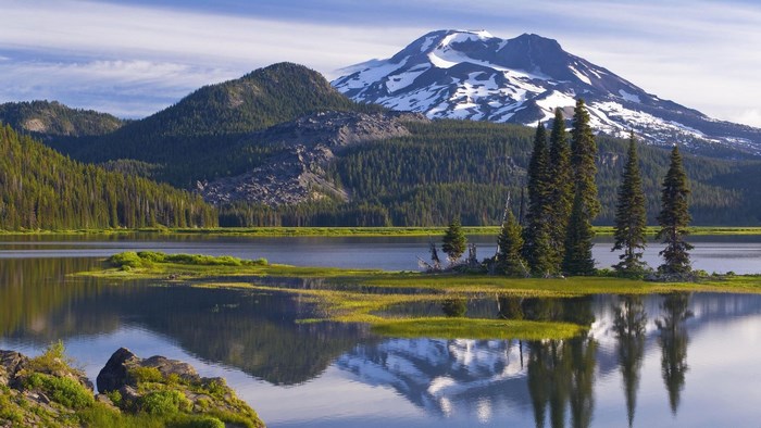 Mountain lake with snow-capped peak and evergreen trees