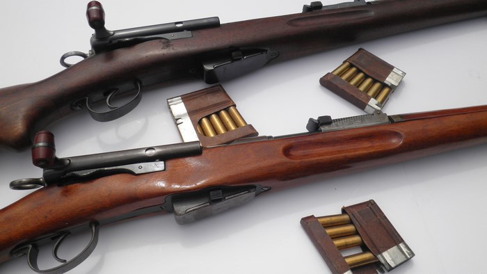 Two Swiss K31 rifles with loaded clips