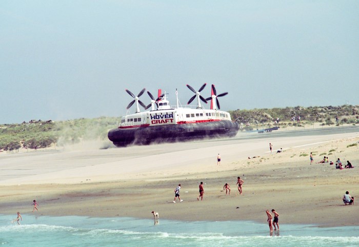 Hovercraft on a sandy beach with people