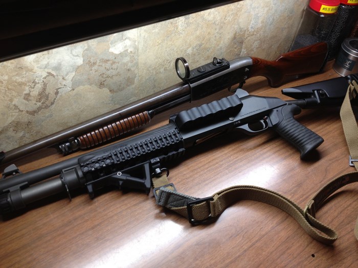 Two shotguns on a wooden table