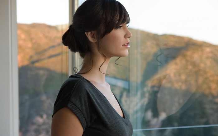 Profile of Woman Looking Through Window with Mountain View