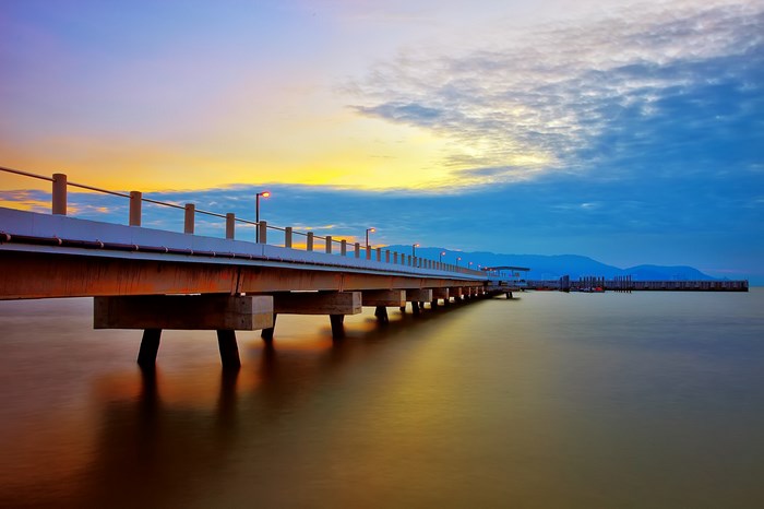 Pier over the ocean at sunset