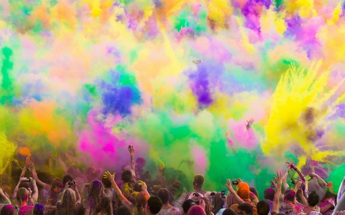 People celebrating Holi with colored powder