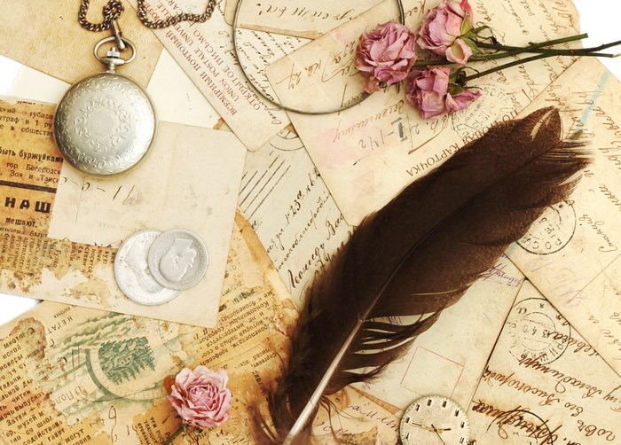 Vintage letters, pocket watch, feather, and roses