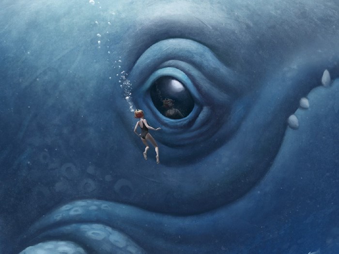 Woman swimming near giant whale eye