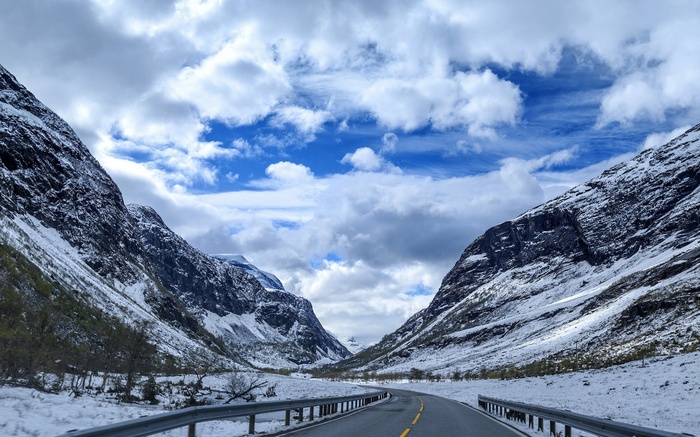 Snowy mountain valley with a winding road