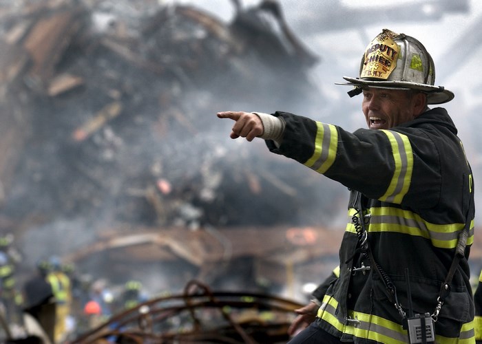 Firefighter pointing at debris at Ground Zero