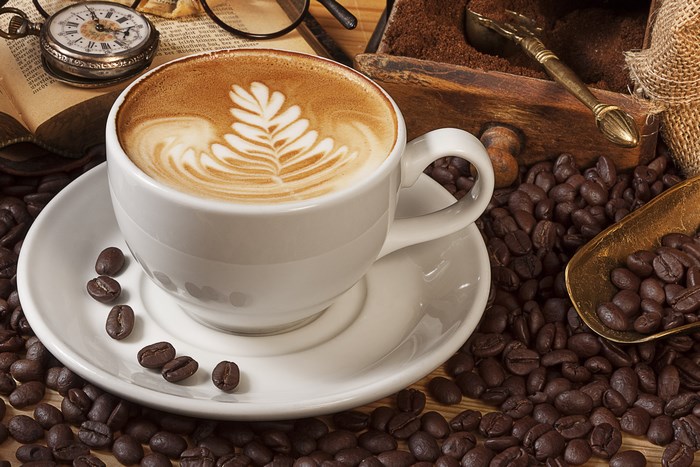 Latte art coffee cup with coffee beans and vintage items