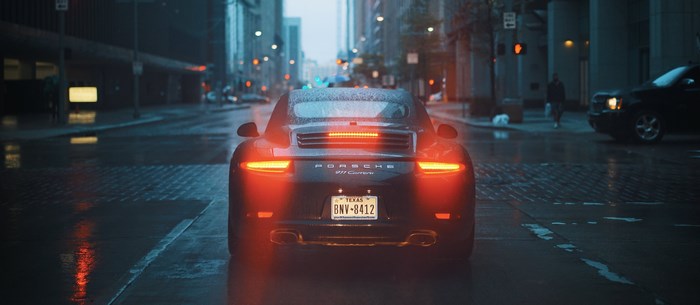 Porsche 911 Carrera on a Rainy City Street