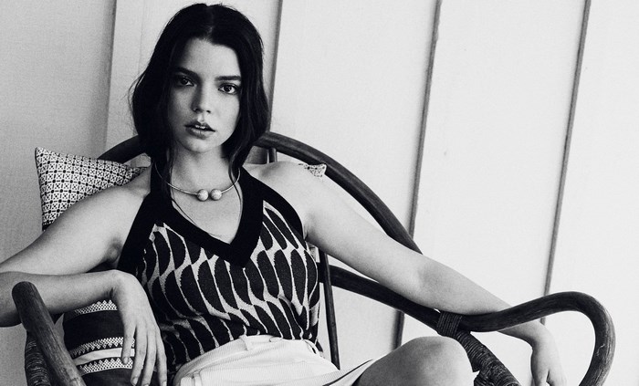 Anya Taylor-Joy sitting in a chair