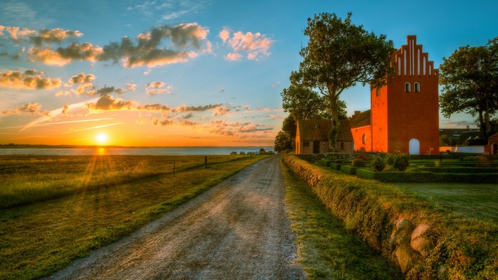 4K Sunset over a rural landscape with a church