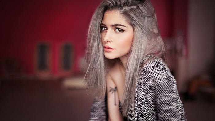 Young woman with grey hair and tattoo