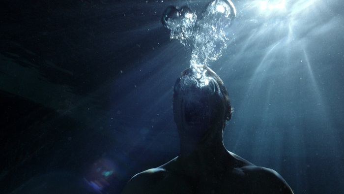 Man underwater exhaling bubbles